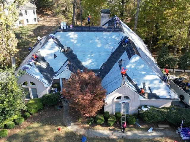 Professional Exteriors crew replacing a roof, aerial view
